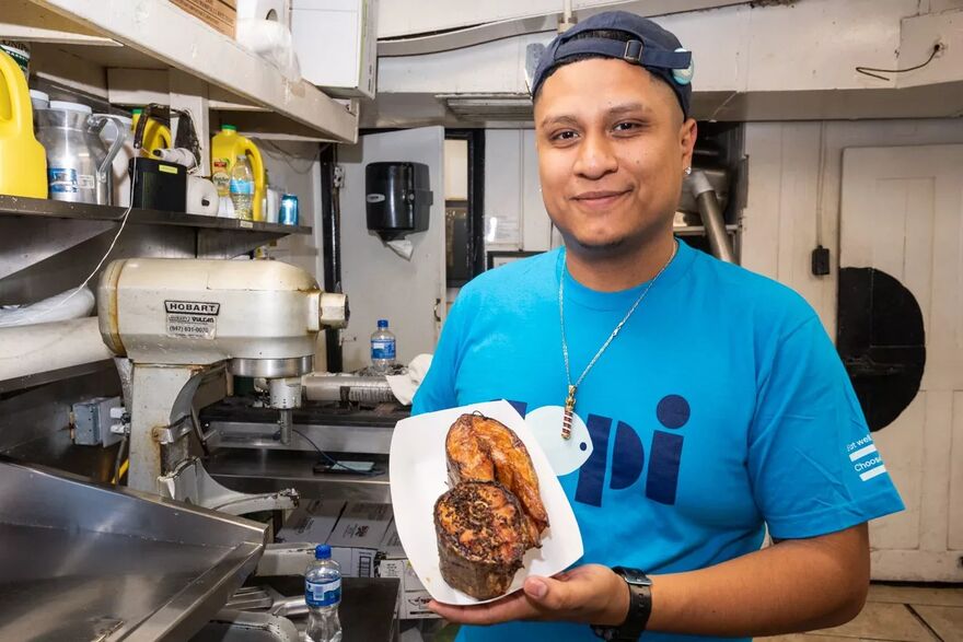 Calumet Fisheries’ chef holds a fillet of smoked Copi